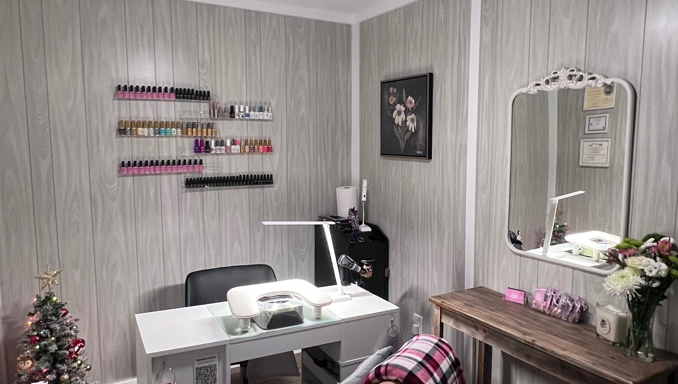 AJ Nails in Oneida, Illinois, US featuring a stylish manicure station with polish display and decorative touches.