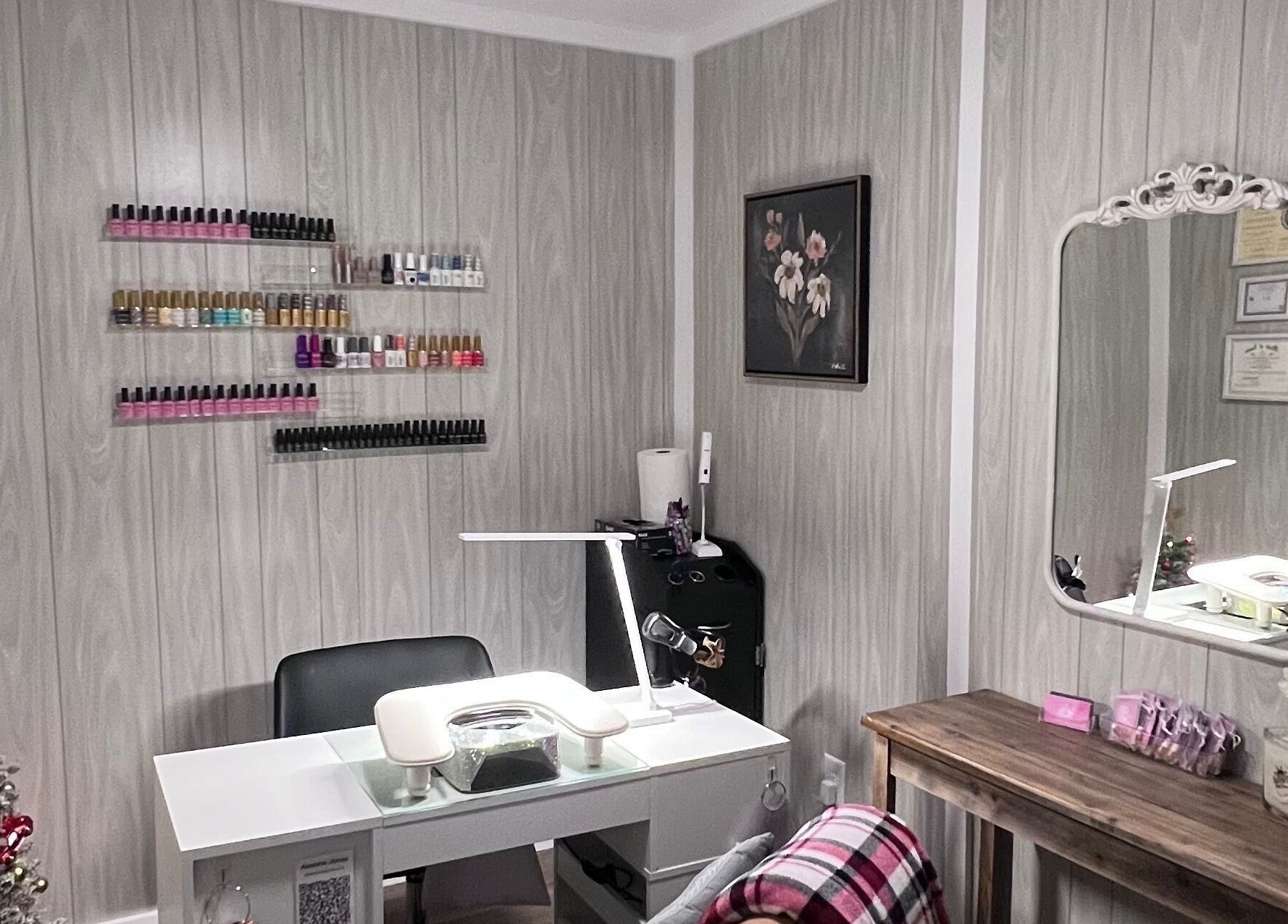 AJ Nails in Oneida, Illinois, US featuring a stylish manicure station with polish display and decorative touches.