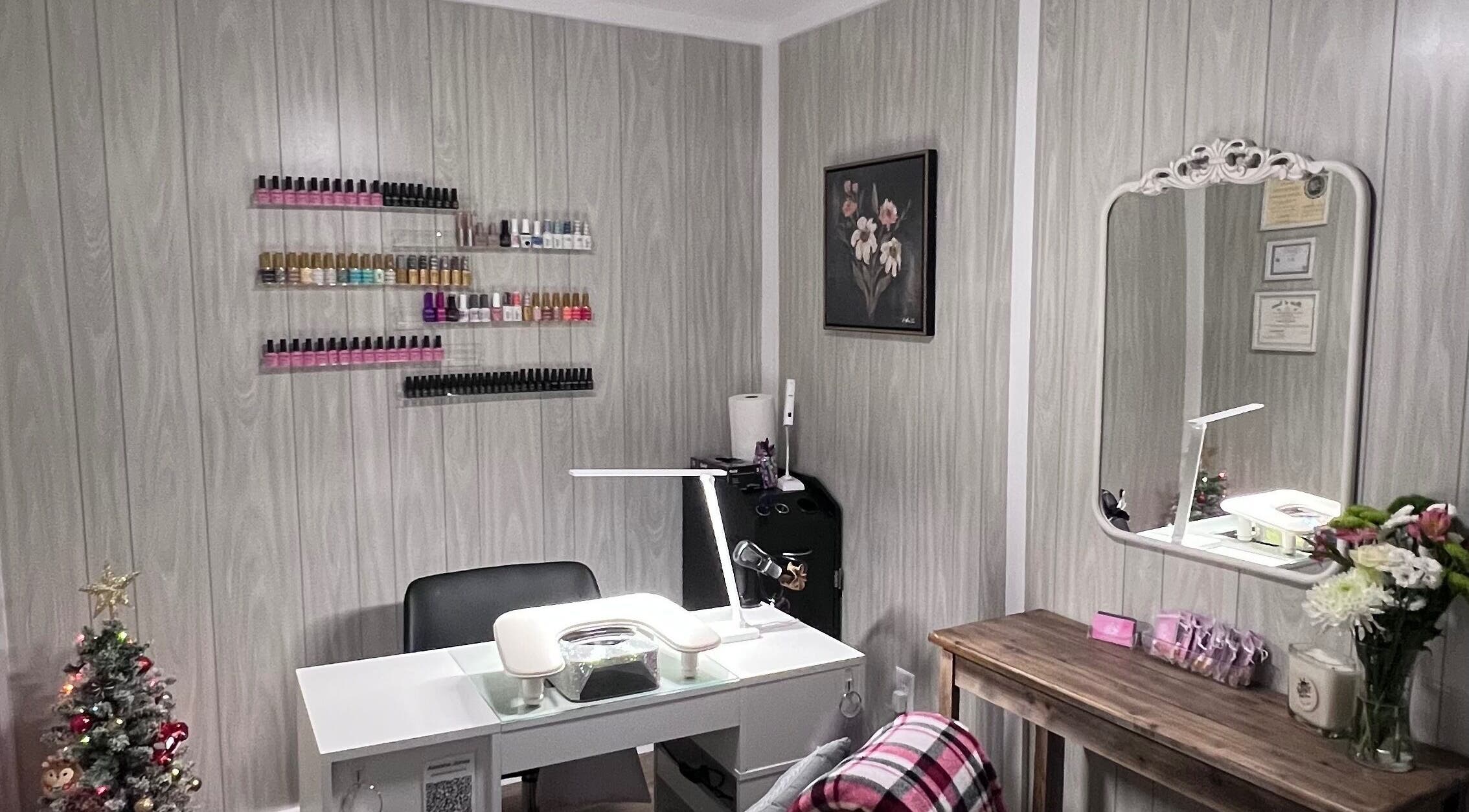 AJ Nails in Oneida, Illinois, US featuring a stylish manicure station with polish display and decorative touches.
