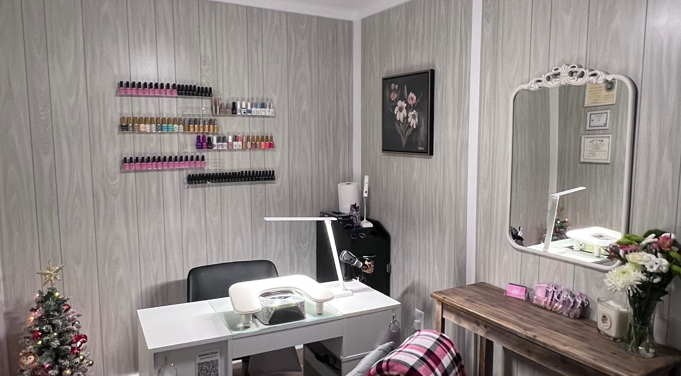 AJ Nails in Oneida, Illinois, US featuring a stylish manicure station with polish display and decorative touches.