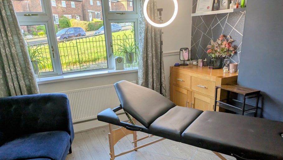 Modern therapy room at Stoke Brow Enchantment in Stoke-on-Trent, England, GB with a massage table and bright decor.