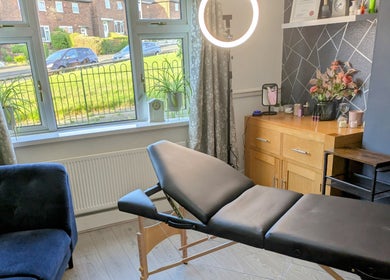 Modern therapy room at Stoke Brow Enchantment in Stoke-on-Trent, England, GB with a massage table and bright decor.