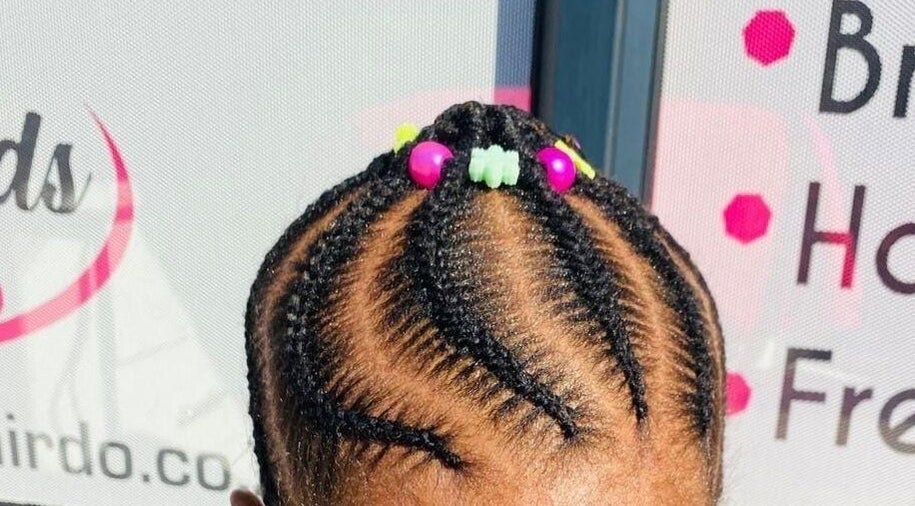 Stylish braided hairstyle with colorful beads at Prettykidshairdo, Pretoria, Gauteng, ZA.