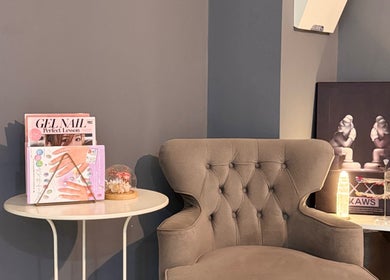 Elegant seating area at BEEQNAILS & LASH STUDIO, Petaling Jaya, Selangor, MY with magazines and decor.