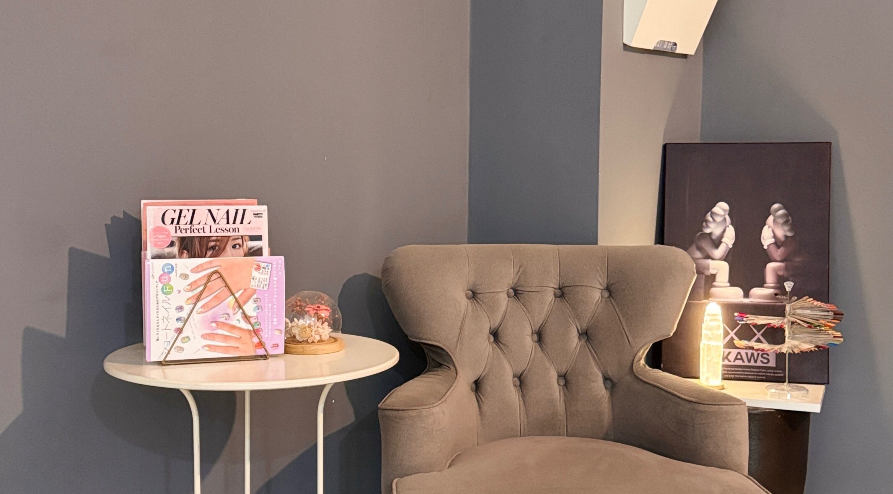 Elegant seating area at BEEQNAILS & LASH STUDIO, Petaling Jaya, Selangor, MY with magazines and decor.