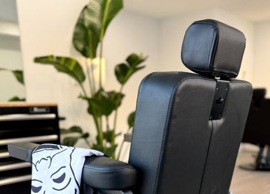 Barber chair at Victory Lap Barbershop, Melbourne, Victoria, AU with vibrant plants in the background.