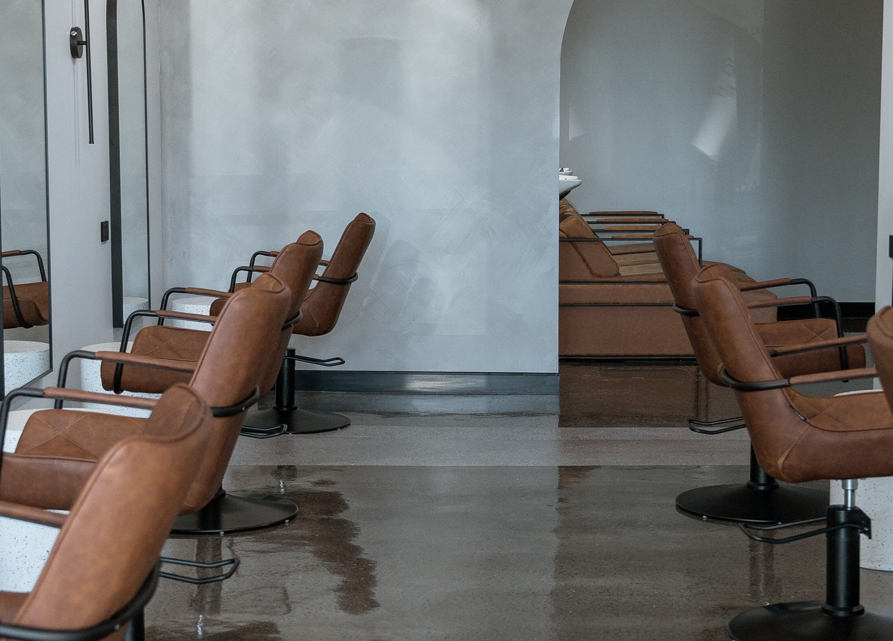 Chic salon chairs at Noho Hair & Co., Ormeau, Queensland, AU, offering elegant hair styling services.