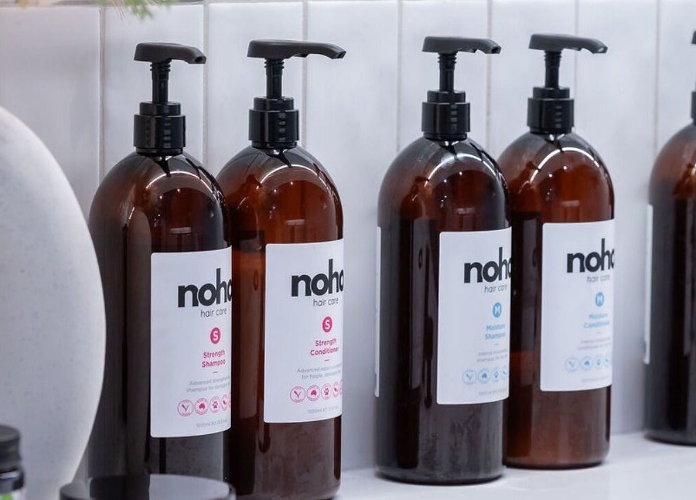 Noho Hair & Co. products on display at Ormeau, Queensland, AU. Elegant bottles for hair care solutions.