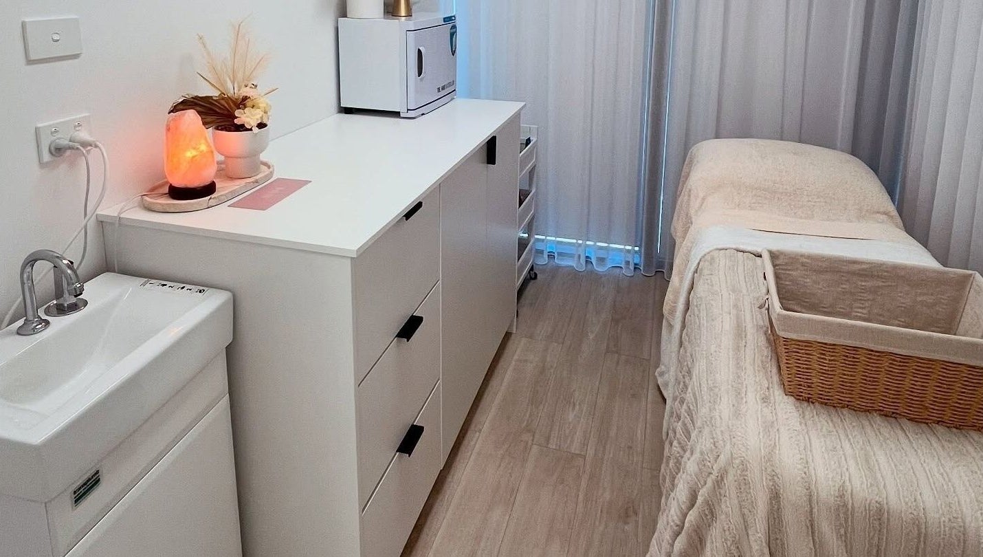 Relaxing treatment room at Ayami, Melbourne, Victoria, AU with ambient lighting and cozy decor.