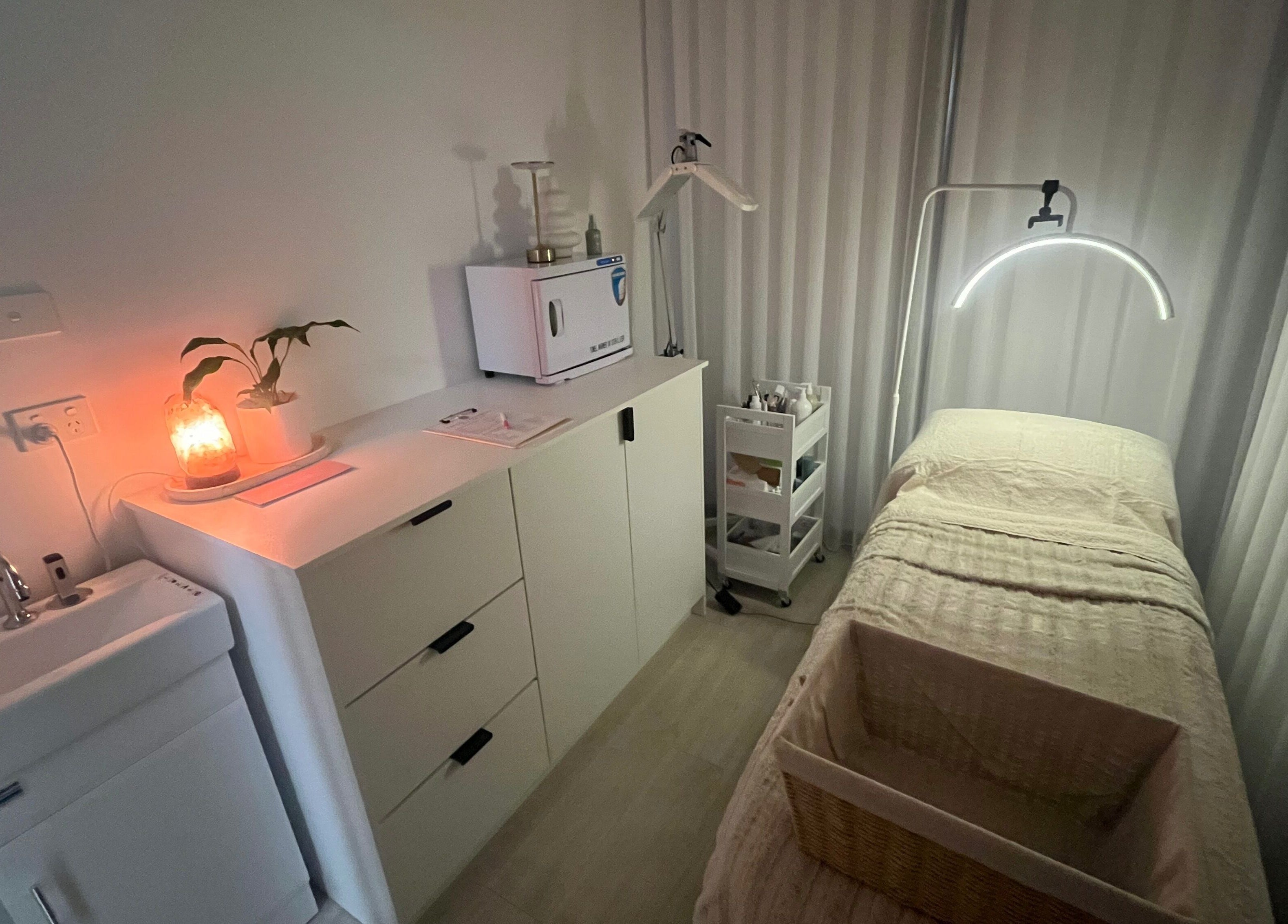 Calming wellness room at Ayami, Melbourne, Victoria, AU with ambient lighting and massage table.