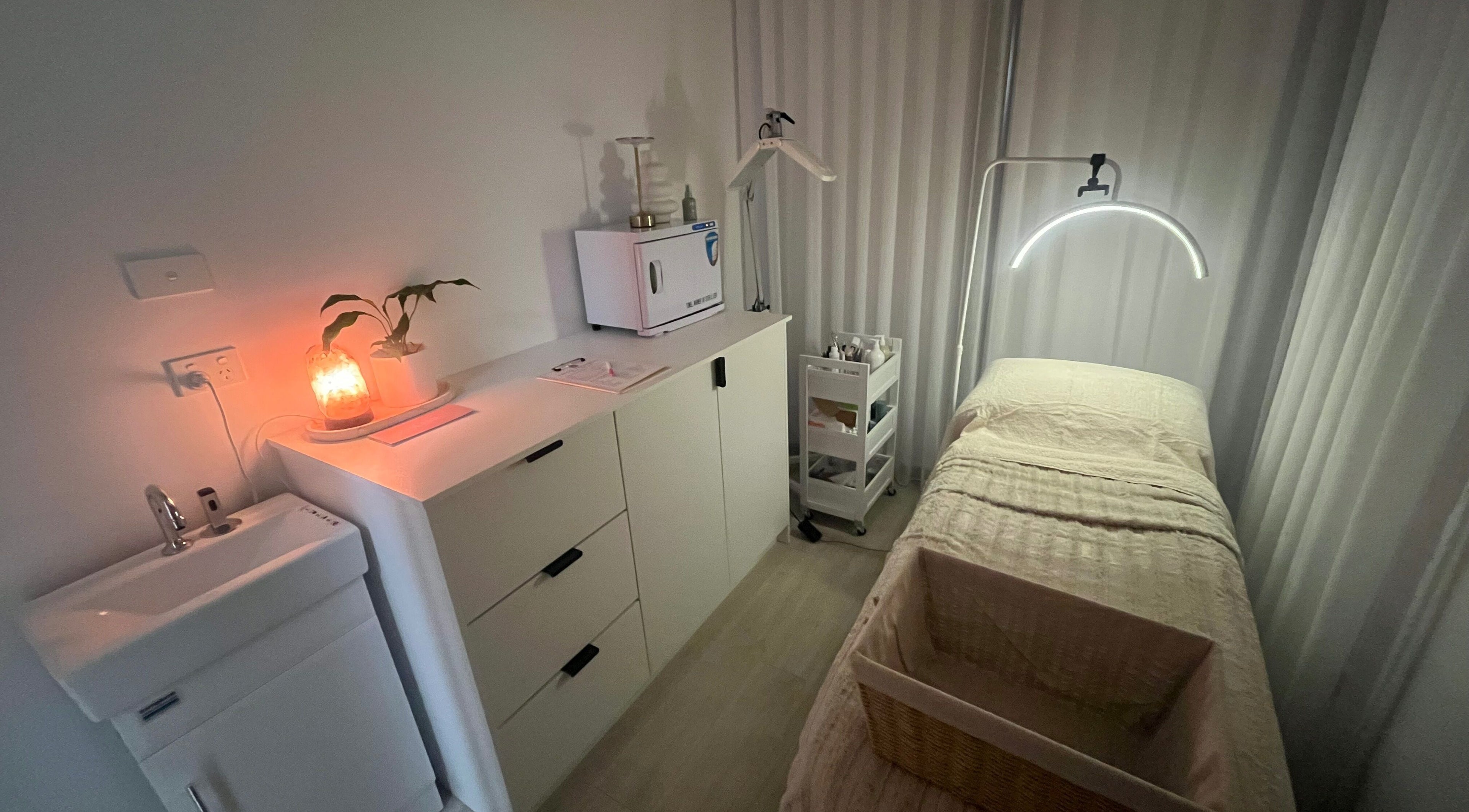Calming wellness room at Ayami, Melbourne, Victoria, AU with ambient lighting and massage table.