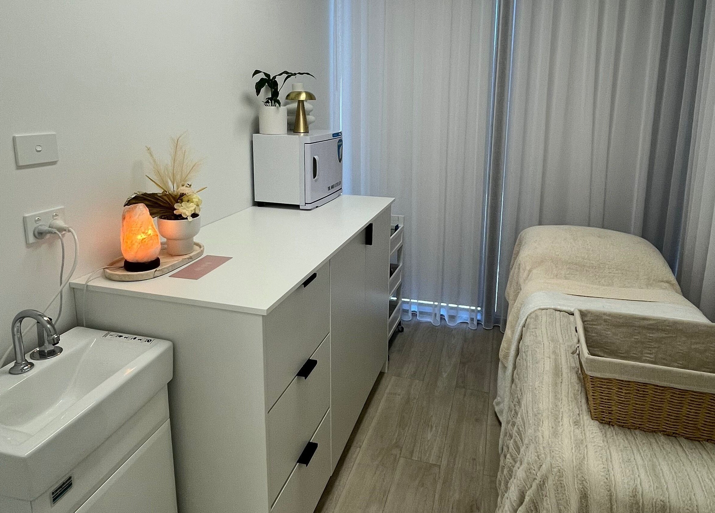 Tranquil treatment room at Ayami in Melbourne, Victoria, AU with cozy decor and ambient lighting.