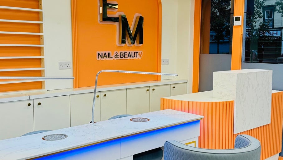 Elegant nail station at EM nail & beauty, Bray, County Wicklow, IE, featuring modern orange and white decor.