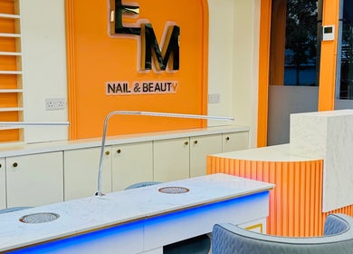 Elegant nail station at EM nail & beauty, Bray, County Wicklow, IE, featuring modern orange and white decor.