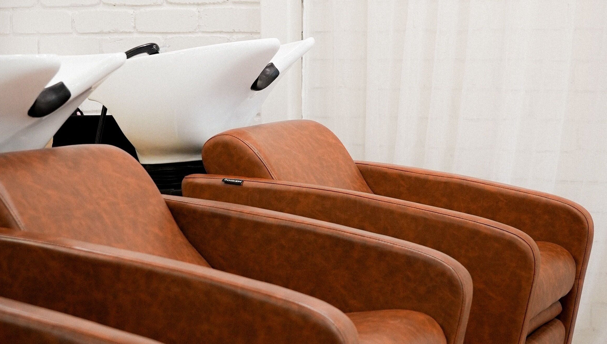 Stylish salon wash stations at Hair by Neomai - WARRAGUL, Warragul, Victoria, AU. Luxurious seating for comfort.