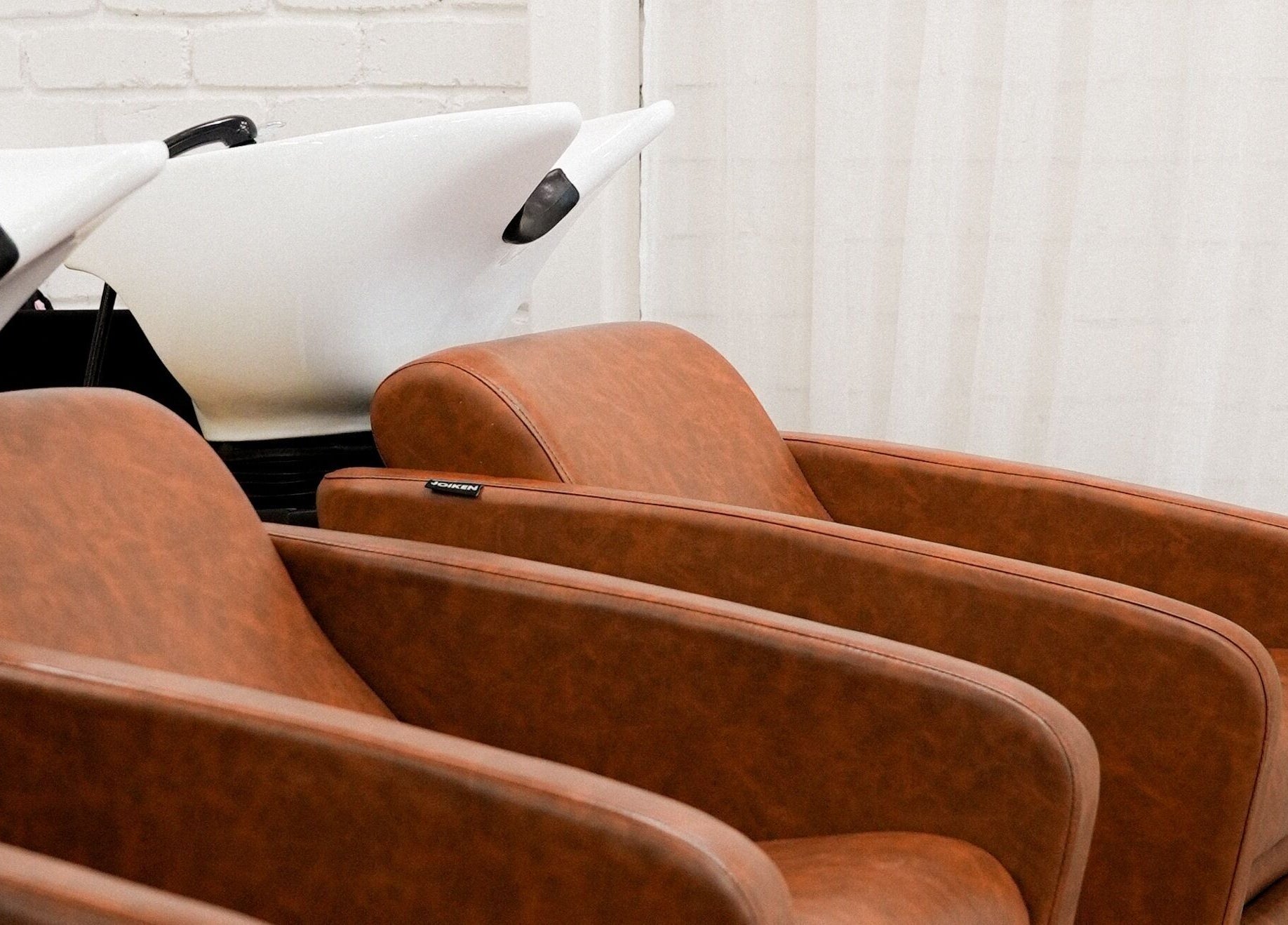 Stylish salon wash stations at Hair by Neomai - WARRAGUL, Warragul, Victoria, AU. Luxurious seating for comfort.