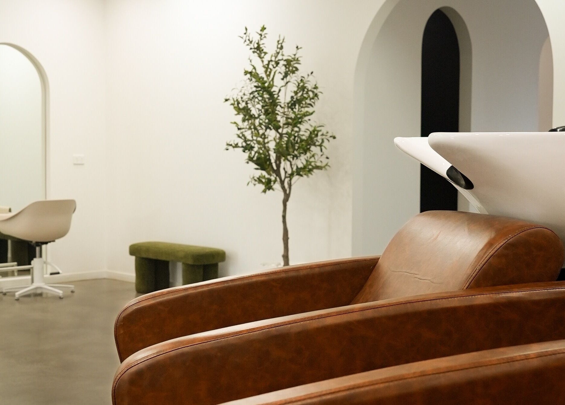 Chic styling chairs and wash basin at Hair by Neomai - WARRAGUL, Warragul, Victoria, AU, creating a cozy ambiance.