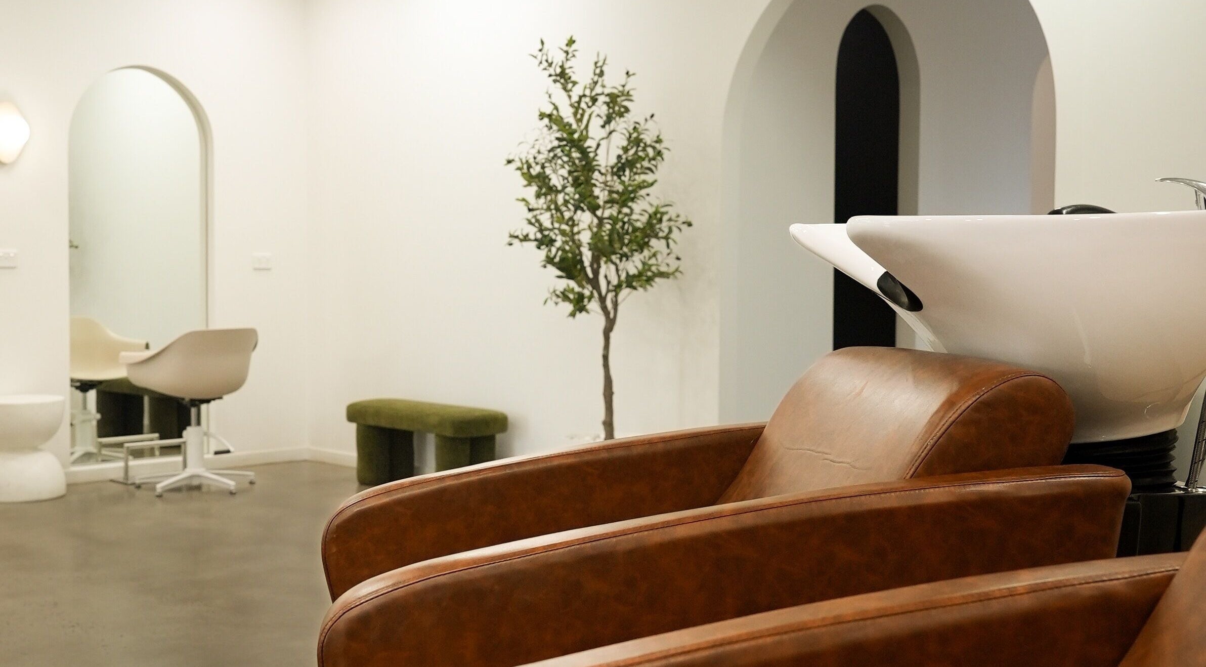 Chic styling chairs and wash basin at Hair by Neomai - WARRAGUL, Warragul, Victoria, AU, creating a cozy ambiance.