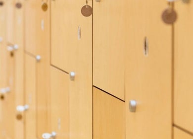 Elegant wooden lockers at By Adriane Roman, London, England, GB, designed for secure visitor storage.