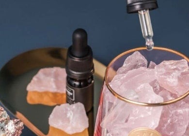 By Adriane Roman's crystal-infused wellness products in London, England, GB. Elegant display with dropper bottle.