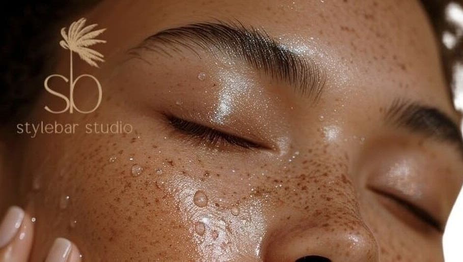 Close-up of a serene face with dewy skin at Stylebar Studio, West Bay, KY.