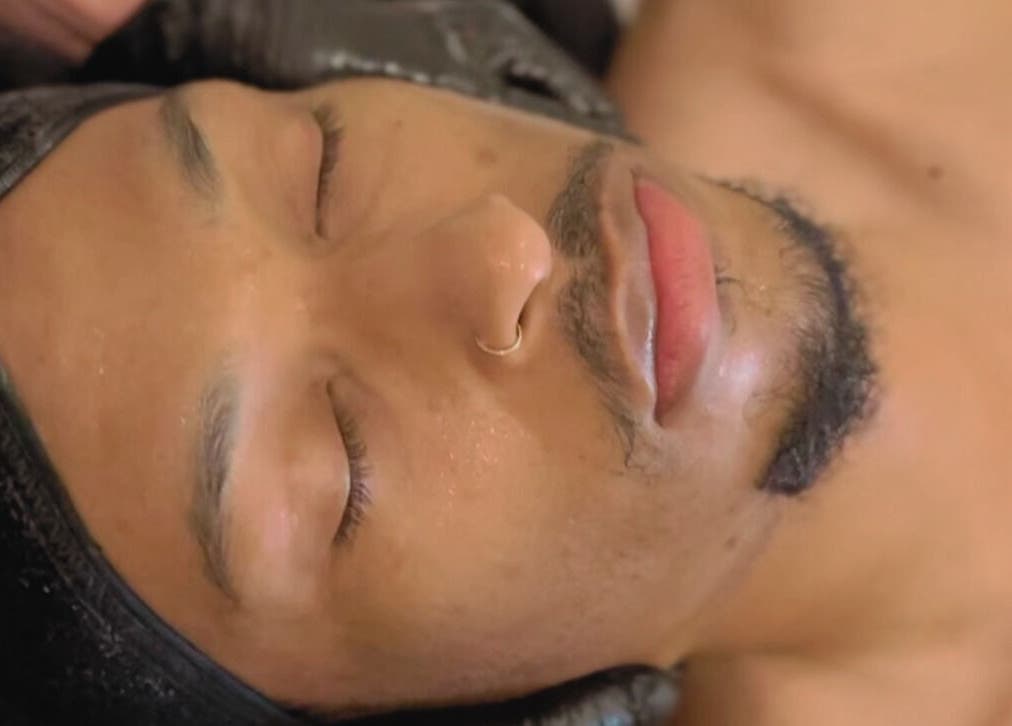 Relaxed individual enjoying facial treatment at Stylebar Studio, West Bay, KY.