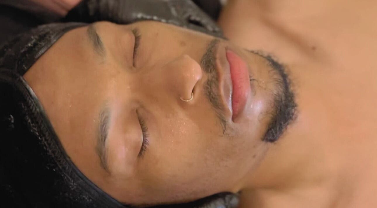 Relaxed individual enjoying facial treatment at Stylebar Studio, West Bay, KY.