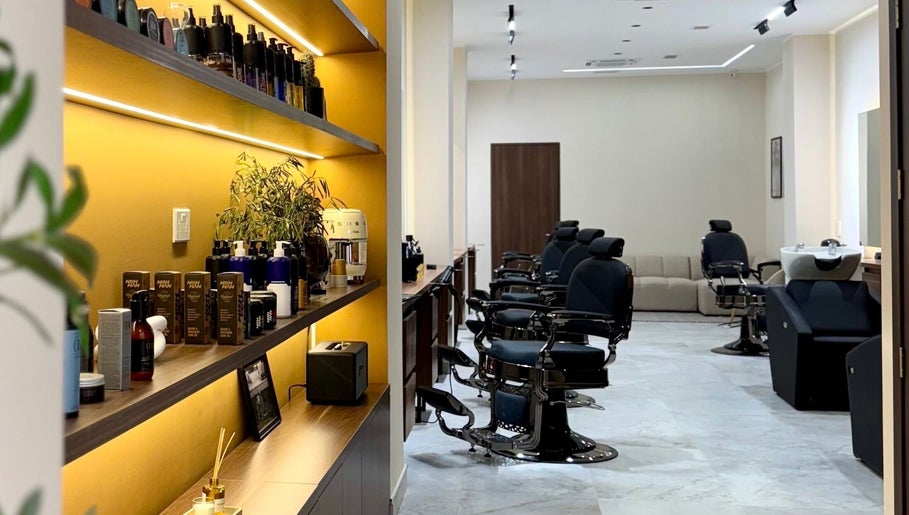 Modern interior of DS Barber Studio in Il-gżira, MT with sleek styling stations and product shelves.