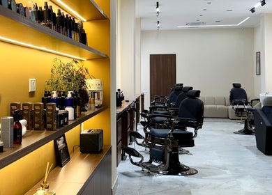 Modern interior of DS Barber Studio in Il-gżira, MT with sleek styling stations and product shelves.