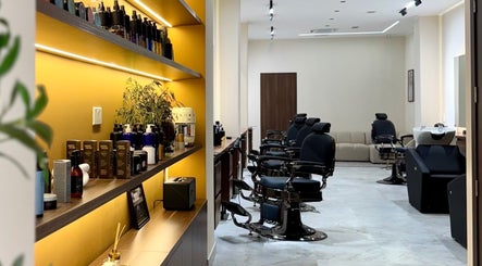 Modern interior of DS Barber Studio in Il-gżira, MT with sleek styling stations and product shelves.