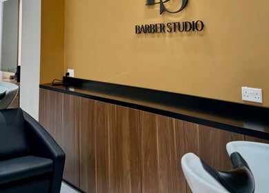 Elegant interior of DS Barber Studio, Il-gżira, MT showcasing sleek chairs and modern design.