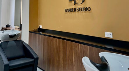 Elegant interior of DS Barber Studio, Il-gżira, MT showcasing sleek chairs and modern design.