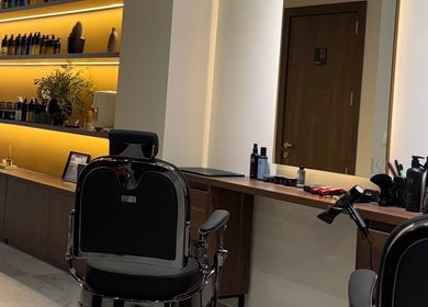 Modern barber chair and stylish shelves inside DS Barber Studio, Il-gżira, MT with grooming products displayed.