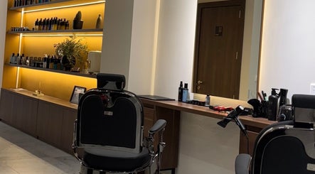 Modern barber chair and stylish shelves inside DS Barber Studio, Il-gżira, MT with grooming products displayed.