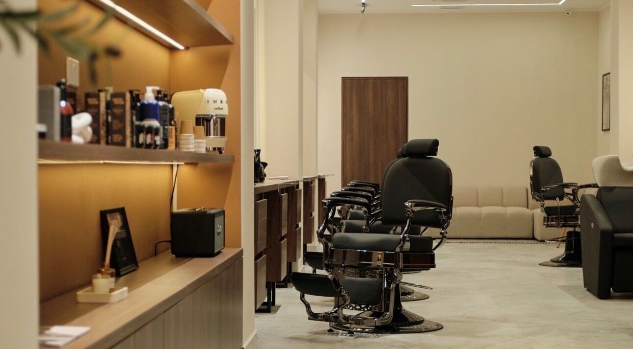Modern interior of DS Barber Studio in Il-gżira, MT showcasing sleek barber chairs and products.