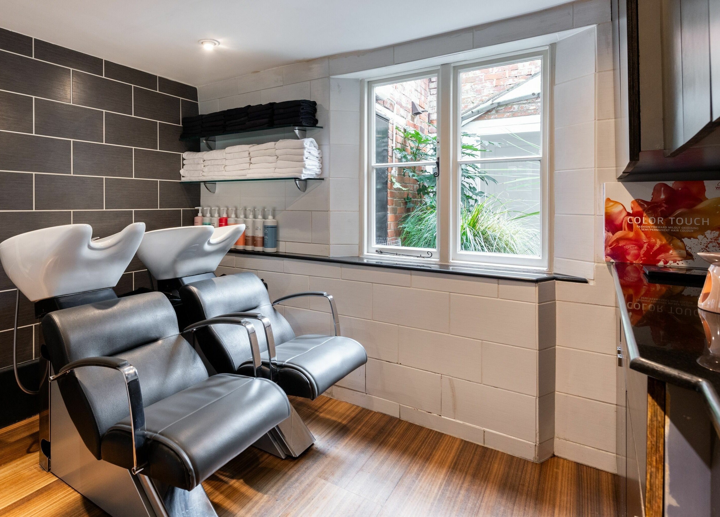 Modern hair washing stations at Albemarle Haircutters, Beaconsfield, England, GB, offering relaxing services.