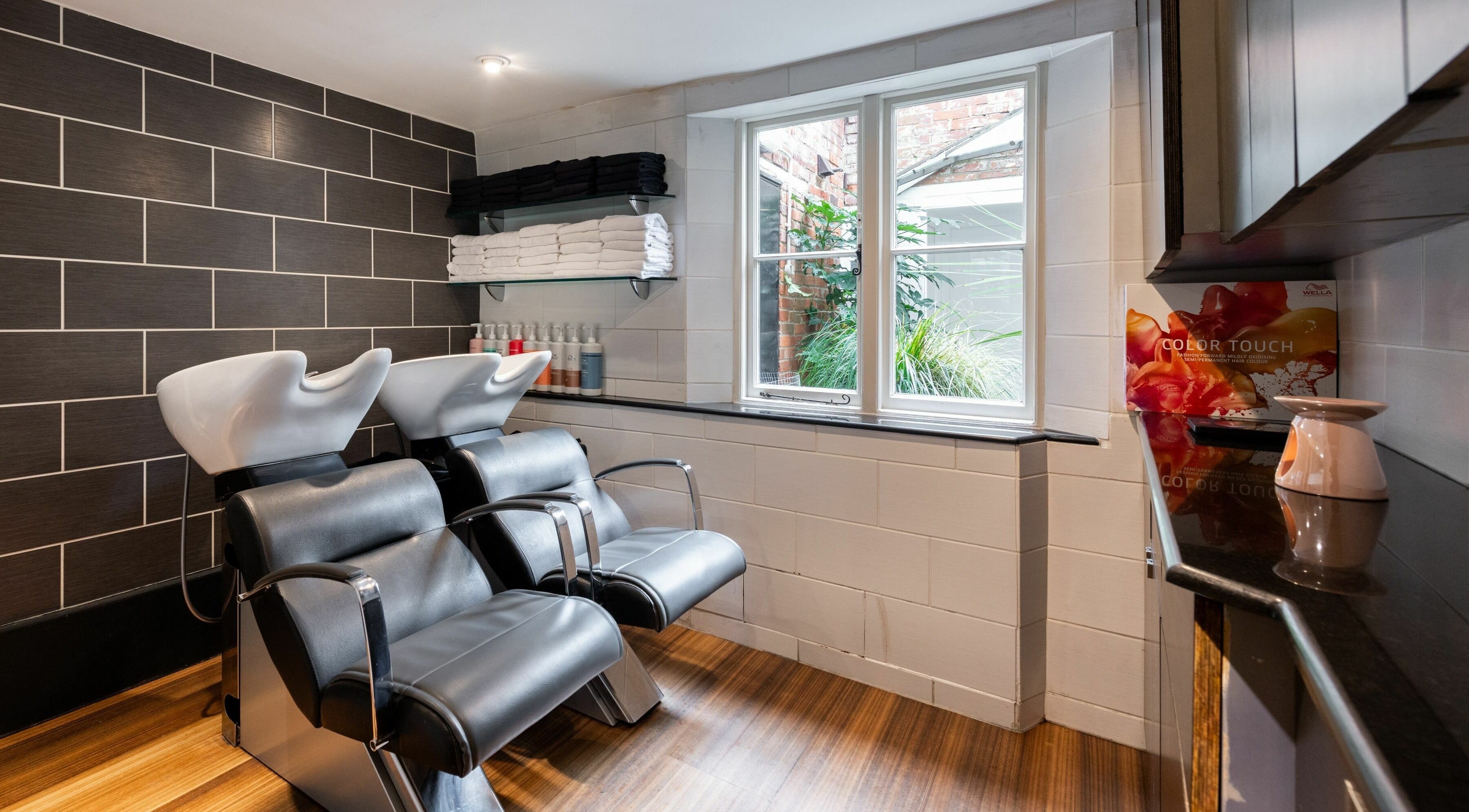 Modern hair washing stations at Albemarle Haircutters, Beaconsfield, England, GB, offering relaxing services.