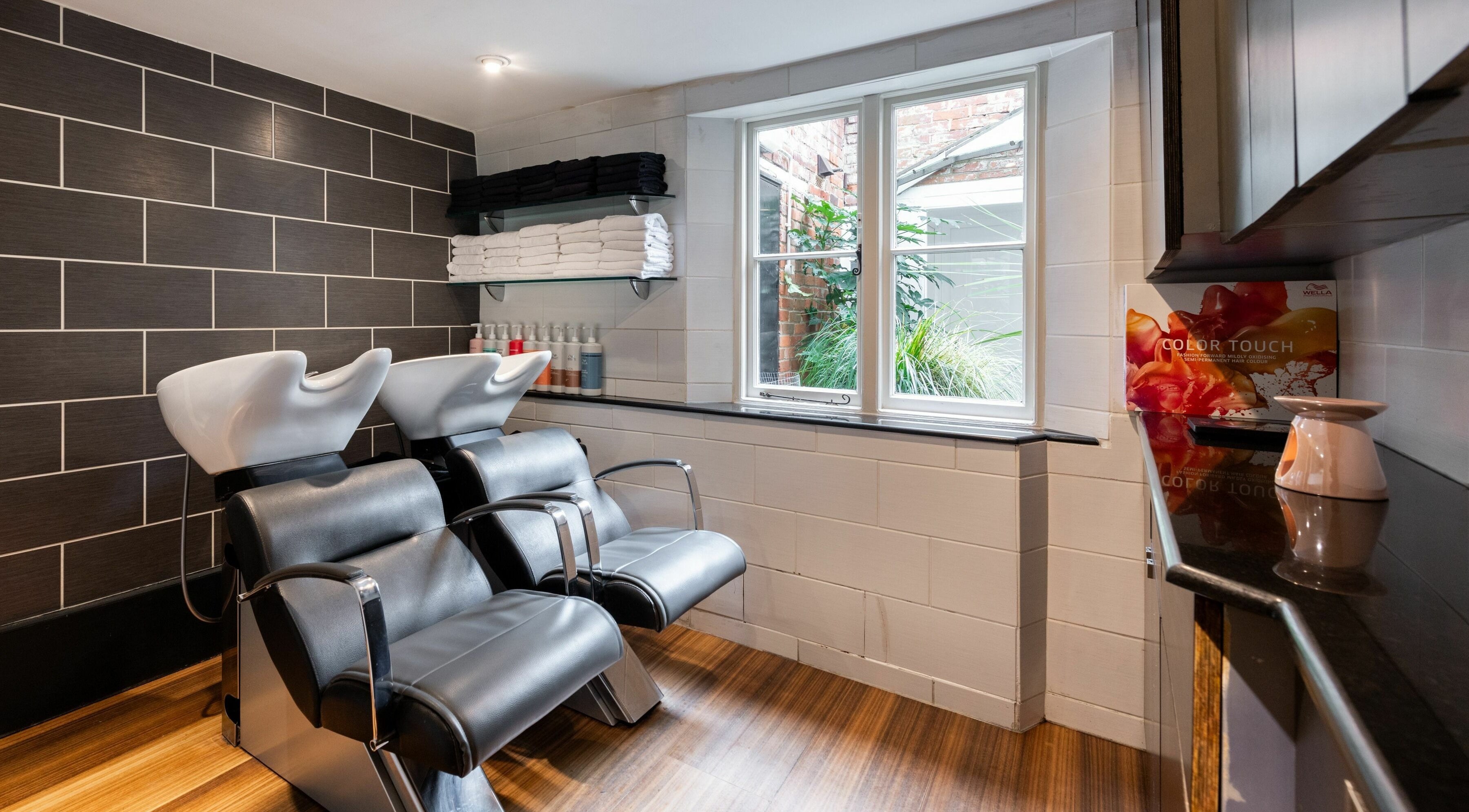 Modern hair washing stations at Albemarle Haircutters, Beaconsfield, England, GB, offering relaxing services.