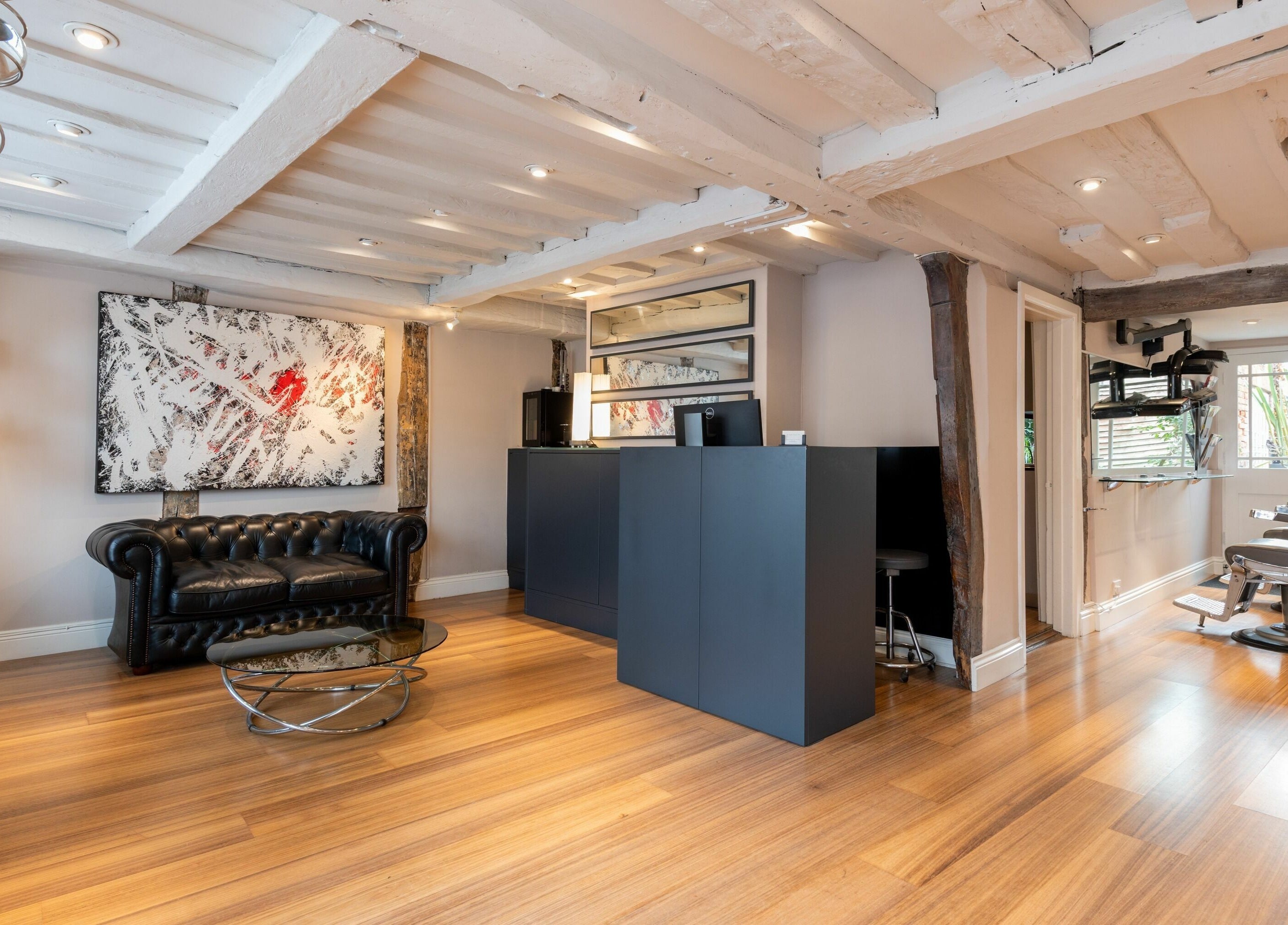 Stylish interior of Albemarle Haircutters in Beaconsfield, England, GB with modern decor and comfy seating.
