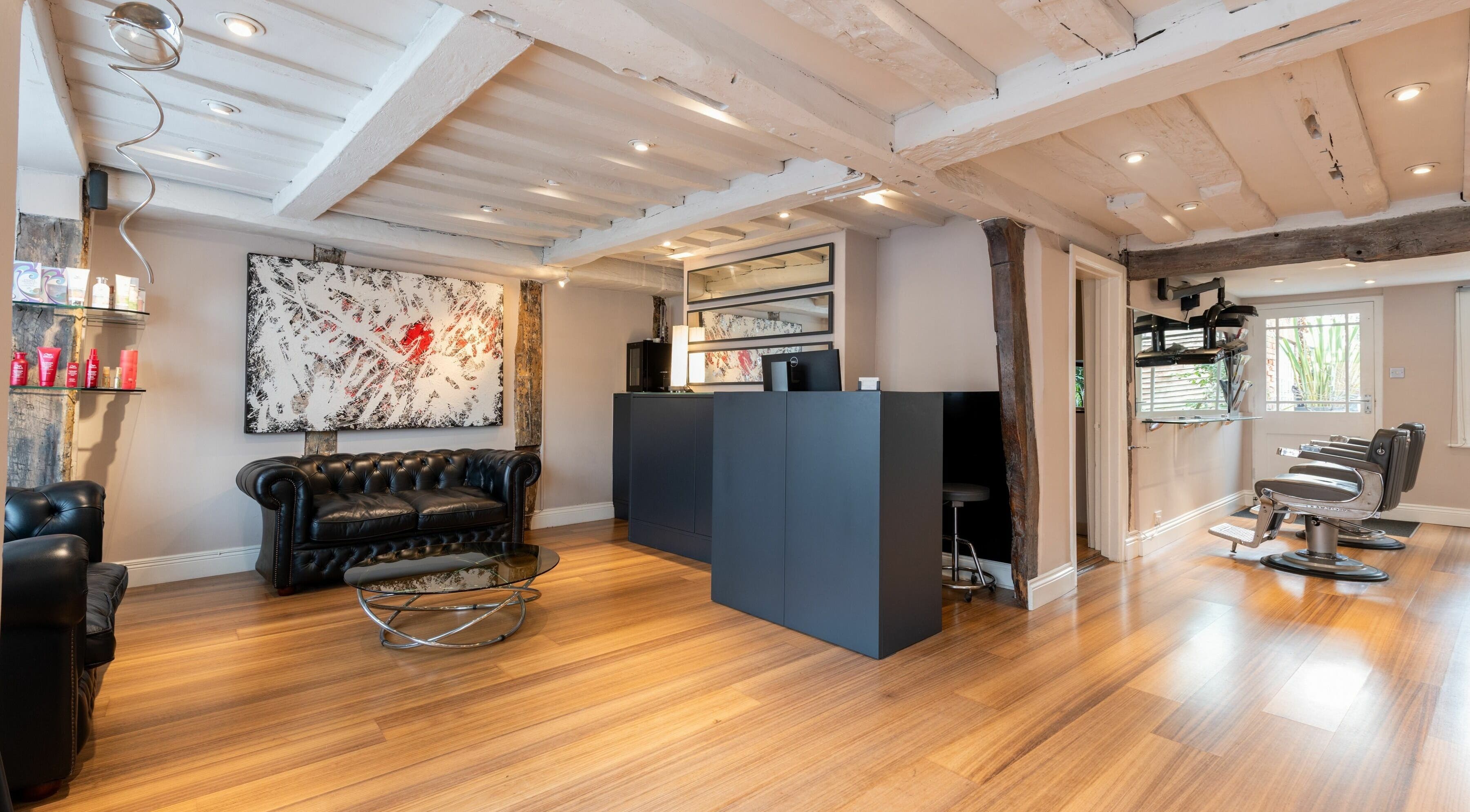 Stylish interior of Albemarle Haircutters in Beaconsfield, England, GB with modern decor and comfy seating.