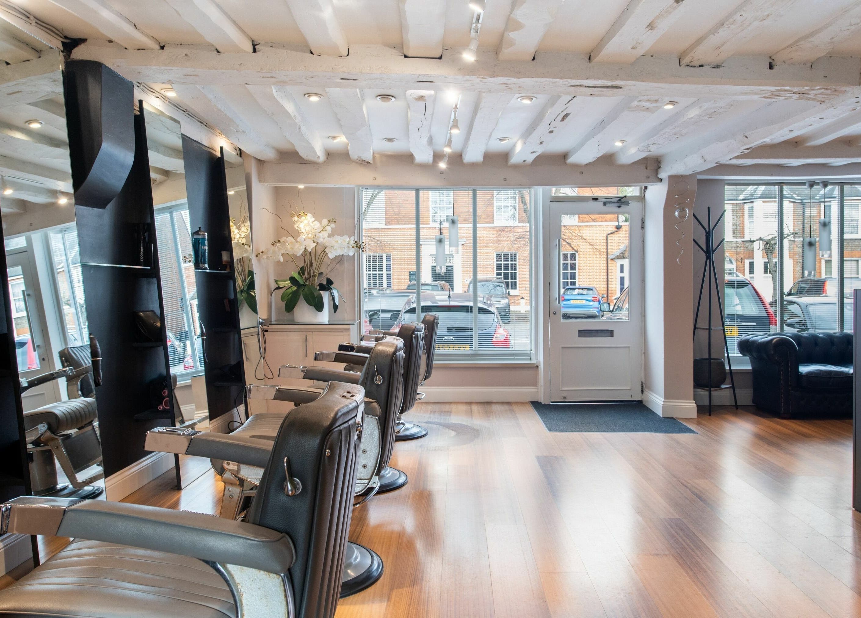 Interior of Albemarle Haircutters in Beaconsfield, England, GB featuring elegant salon chairs and a modern design.