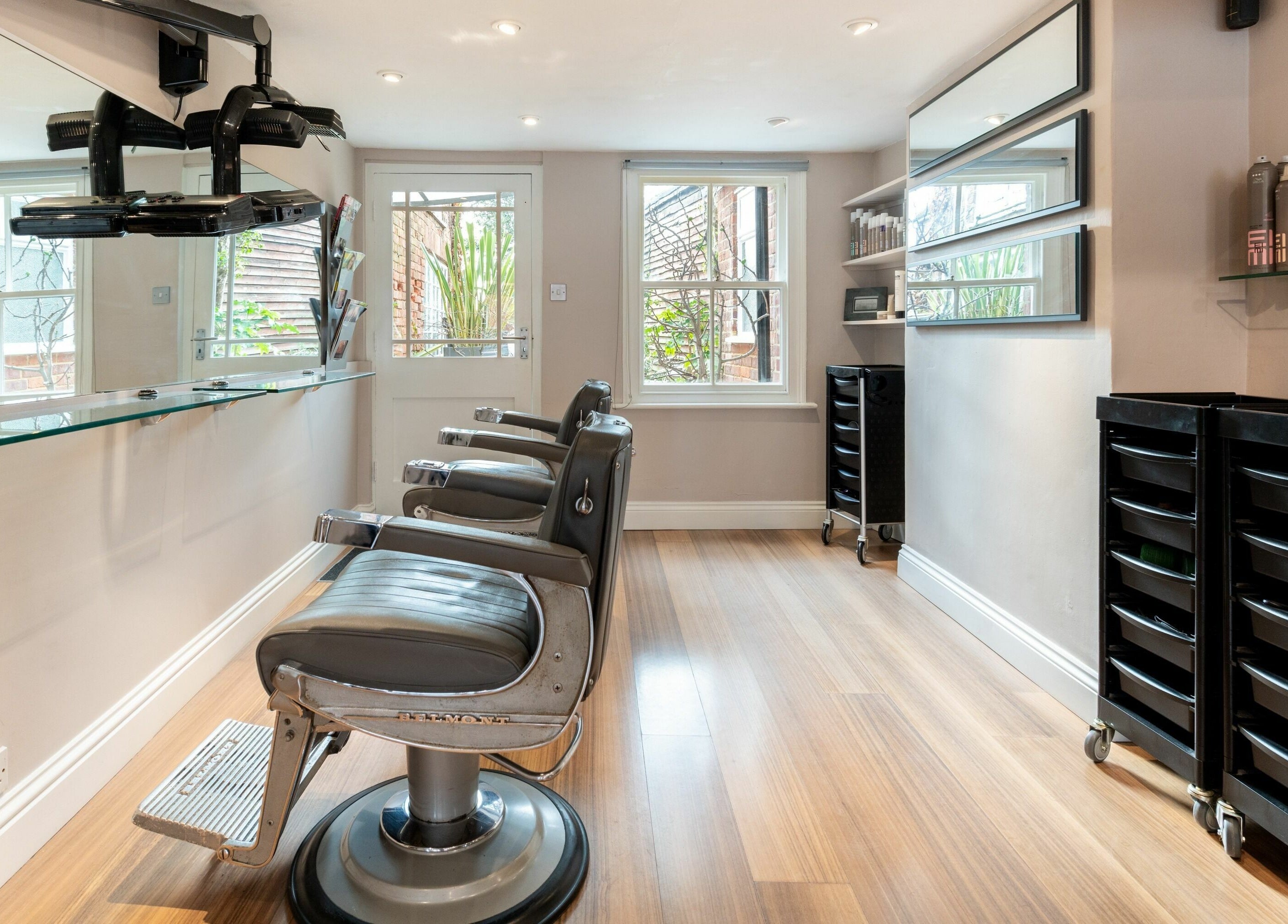 Interior of Albemarle Haircutters, Beaconsfield, England, GB with stylish barber chairs and modern decor.