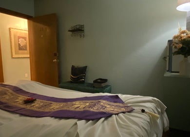 Tranquil massage room at LV Thai Massage & Spa, Las Vegas, Nevada, US with flower decor and soft lighting.