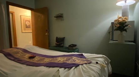 Tranquil massage room at LV Thai Massage & Spa, Las Vegas, Nevada, US with flower decor and soft lighting.
