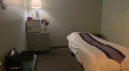 Peaceful massage room at LV Thai Massage & Spa in Las Vegas, Nevada, US with table and warm lighting.