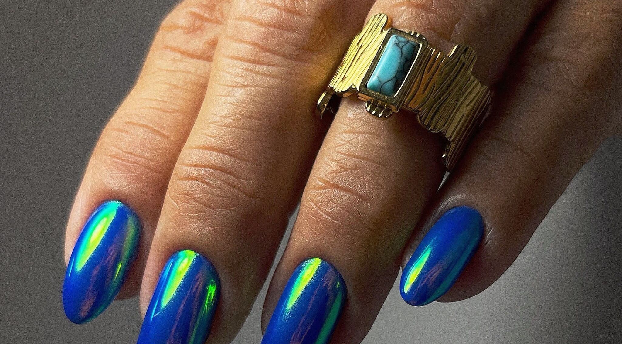 Manicura azul brillante en The Rad Studio, San Sebastián, San Sebastián, PR. Destacando anillo dorado.