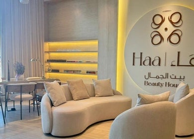 Modern interior of Haa Beauty House in Al Khobar, Eastern Province, SA with elegant seating and logo.