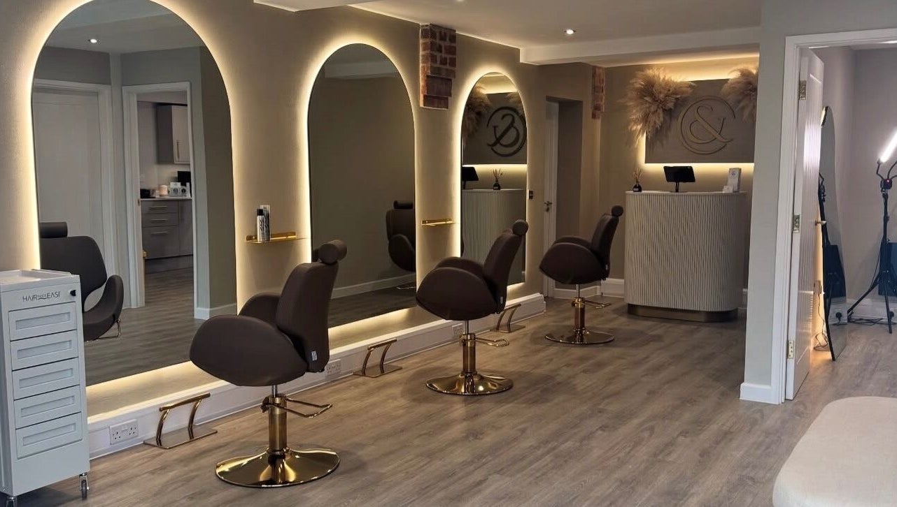 Elegant interior of Blushed Bykyra in Upton, England, GB featuring salon chairs and illuminated mirrors.