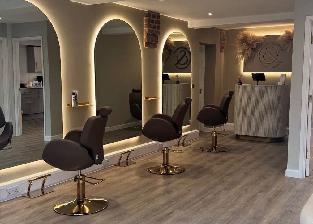Elegant interior of Blushed Bykyra in Upton, England, GB featuring salon chairs and illuminated mirrors.