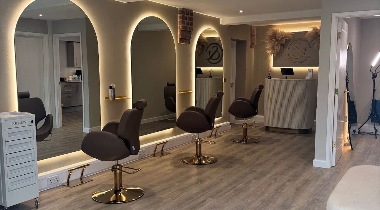 Elegant interior of Blushed Bykyra in Upton, England, GB featuring salon chairs and illuminated mirrors.